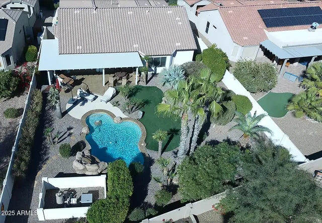 a view of a house with backyard porch and sitting area