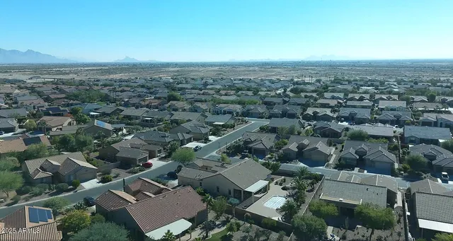 an aerial view of a house with yard swimming pool and lake view