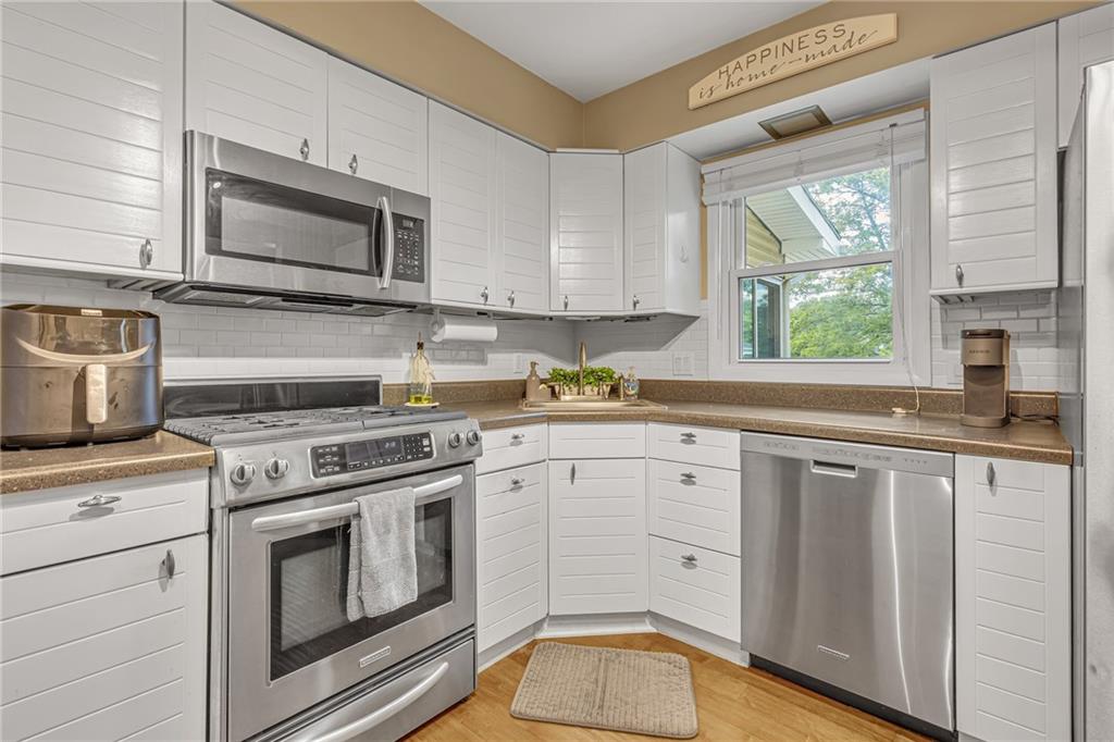 106 Truman Street Monaca, PA 15061 - Photo 11 of 25 a kitchen with white cabinets appliances and a window