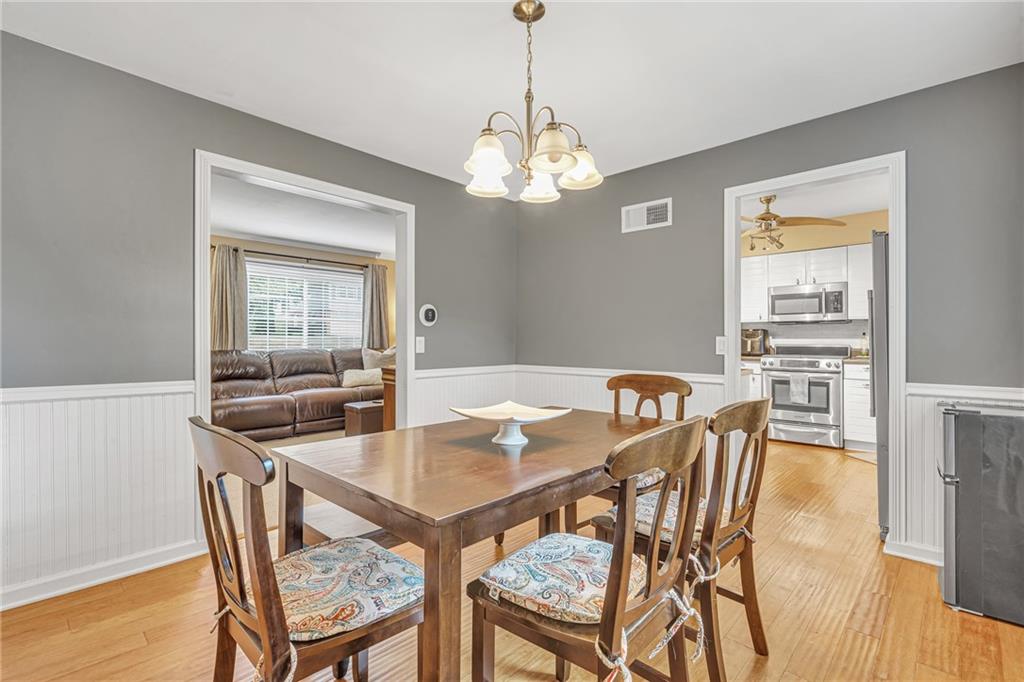 106 Truman Street Monaca, PA 15061 - Photo 14 of 25 a view of a dining room with furniture a chandelier and wooden floor