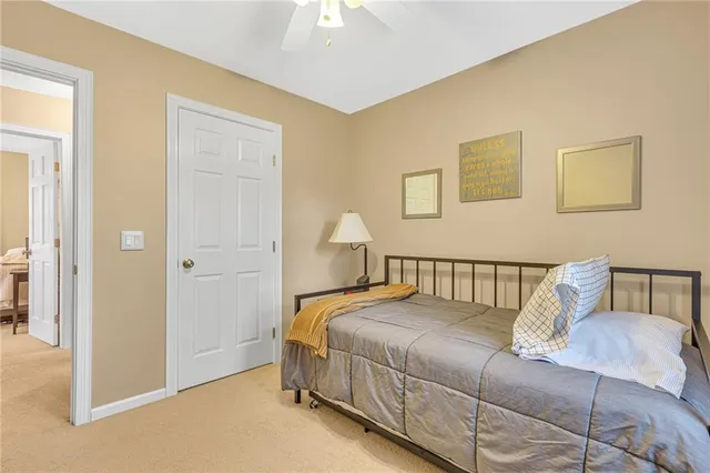 a bedroom with a bed and a lamp