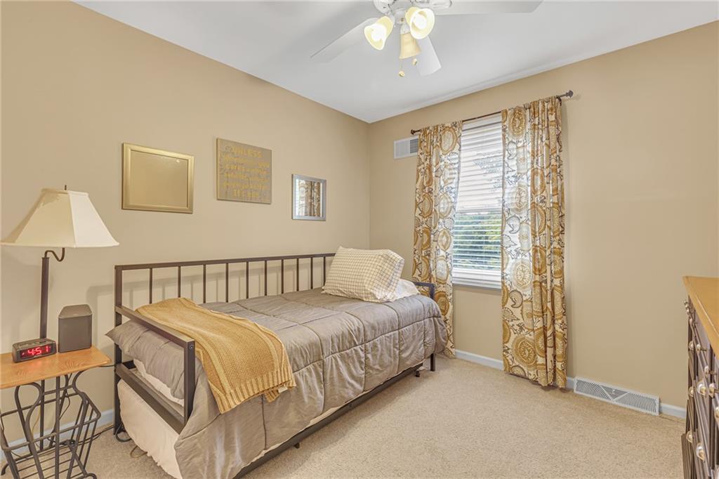 106 Truman Street Monaca, PA 15061 - Photo 18 of 25 a bed sitting in a bedroom next to a lamp