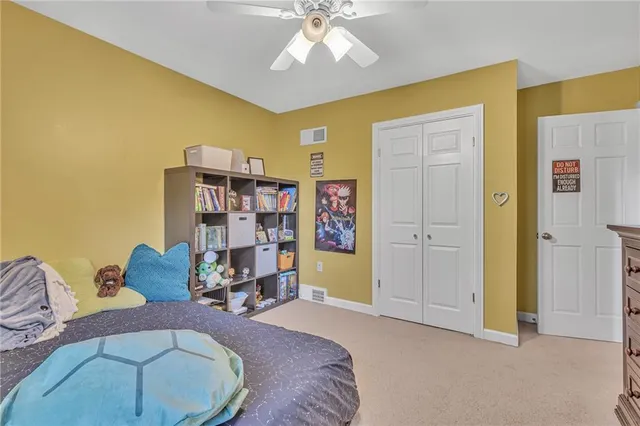 a bed room with a bed and a chair