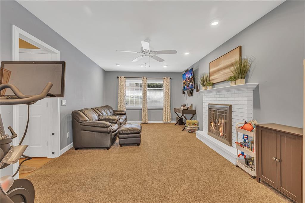 106 Truman Street Monaca, PA 15061 - Photo 6 of 25 a living room with furniture a fireplace and a flat screen tv