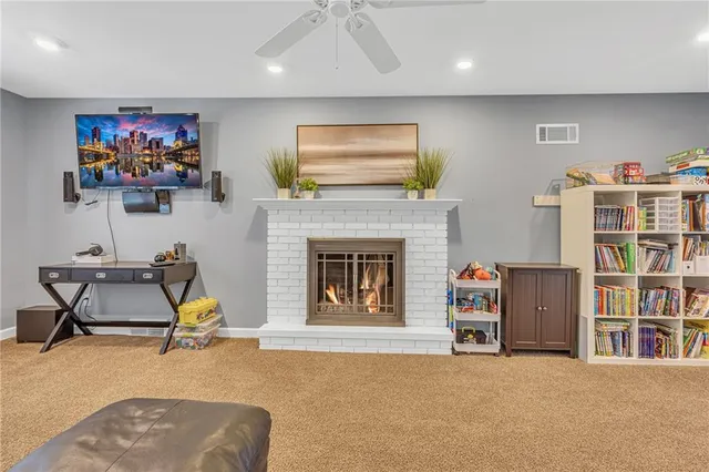 a living room with furniture and a fireplace