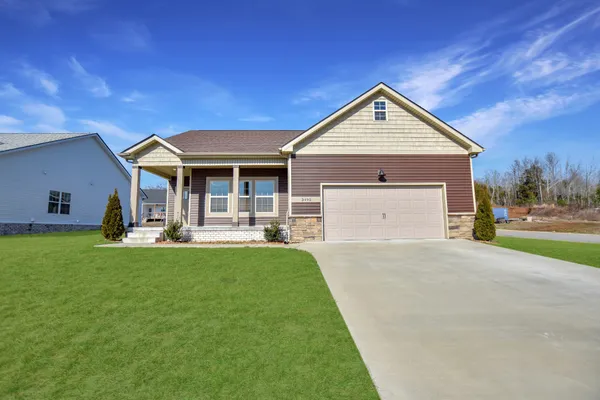 a front view of house with yard and outdoor seating