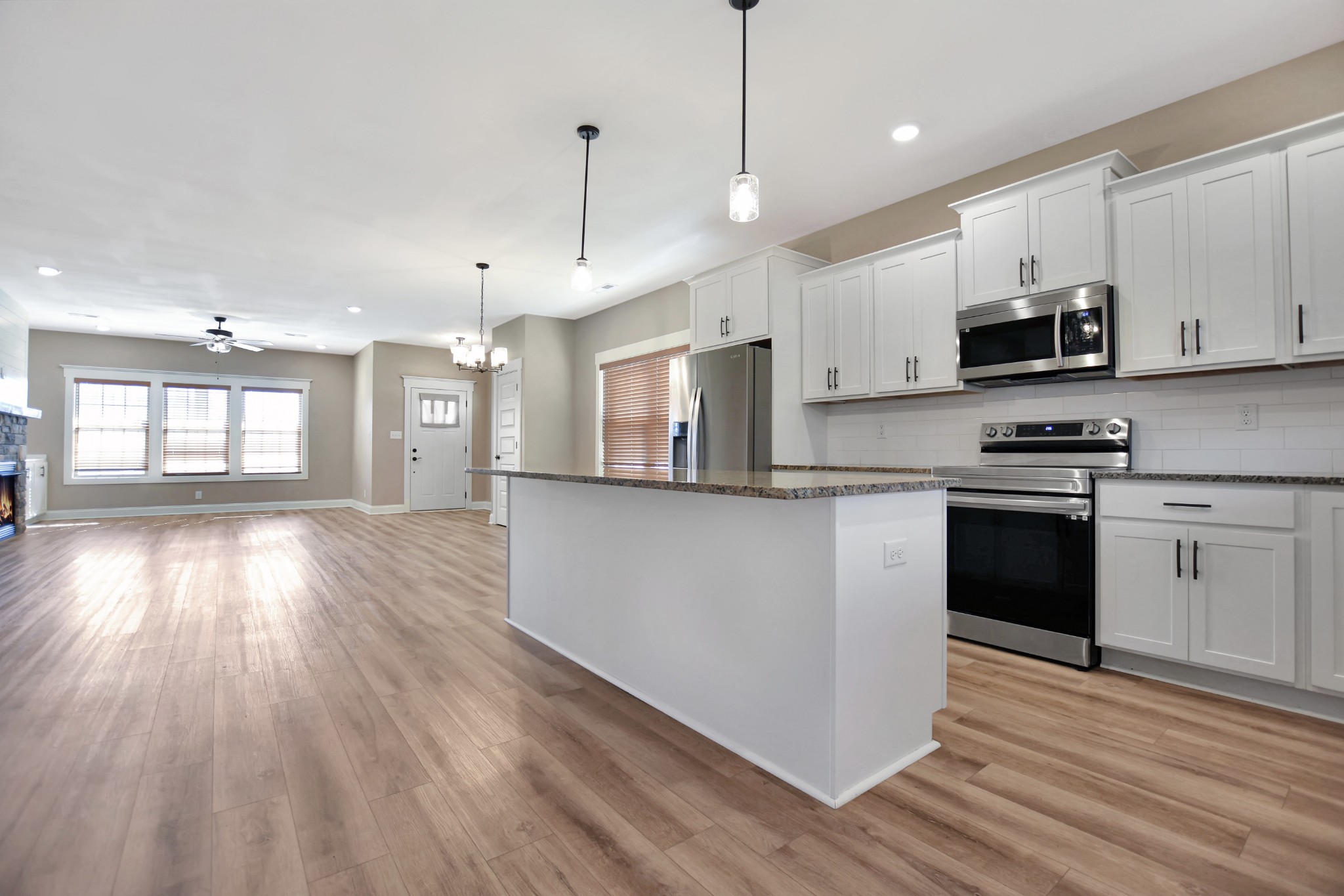3495 Rabbit Run Trail Clarksville, TN 37043 - Photo 11 of 27 a kitchen with stainless steel appliances granite countertop a stove a sink and a refrigerator