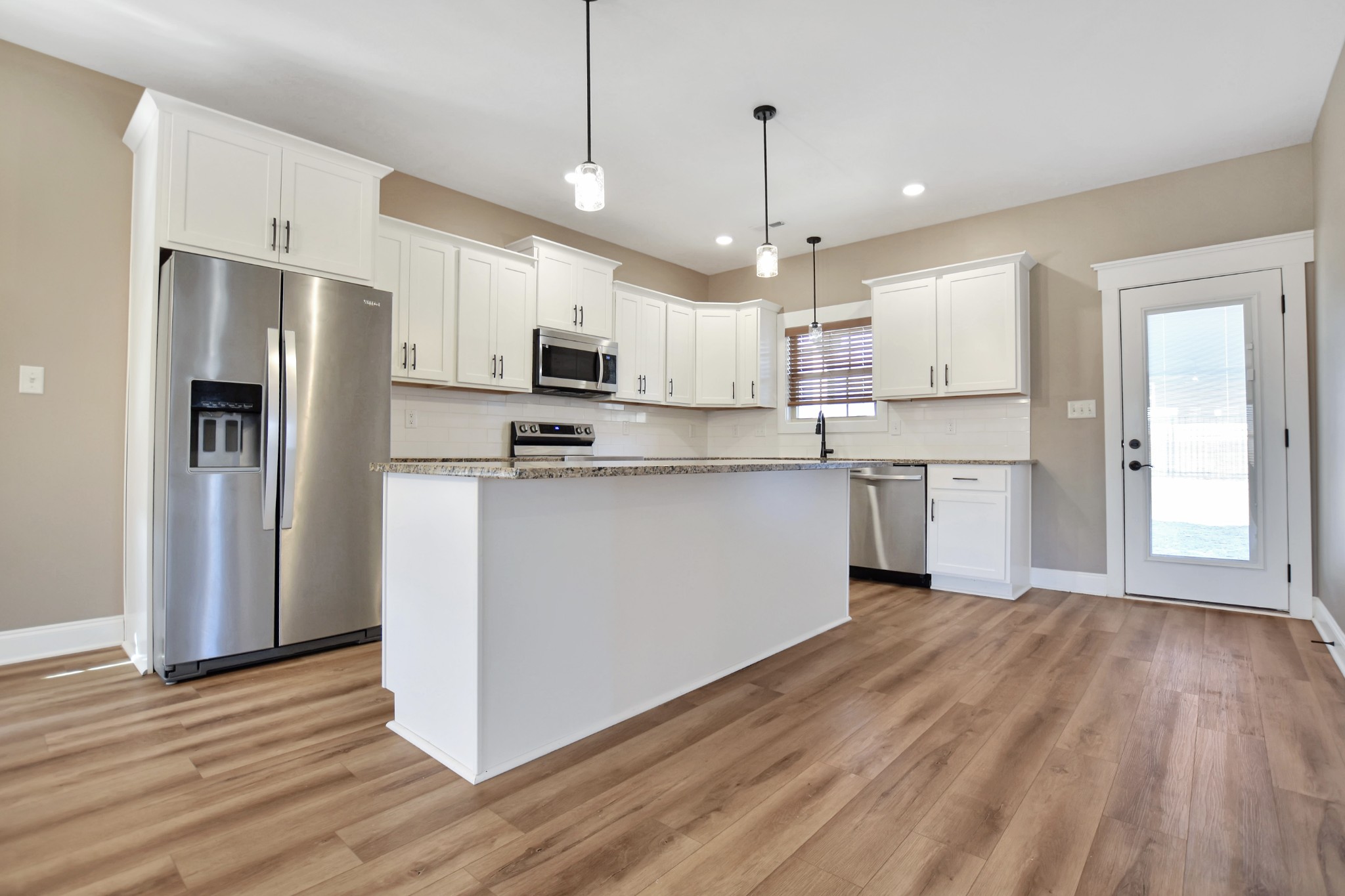 3495 Rabbit Run Trail Clarksville, TN 37043 - Photo 12 of 27 a kitchen with stainless steel appliances granite countertop a refrigerator a stove top oven a sink dishwasher and a refrigerator with wooden floor