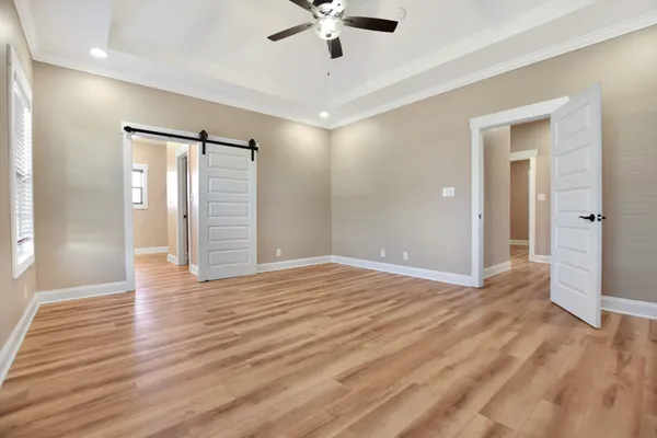 a view of an empty room with wooden floor