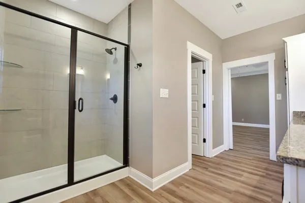 a bathroom with a glass shower door