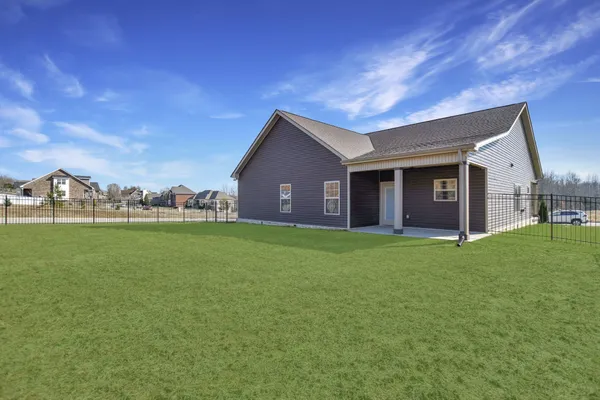 a view of a house with a backyard