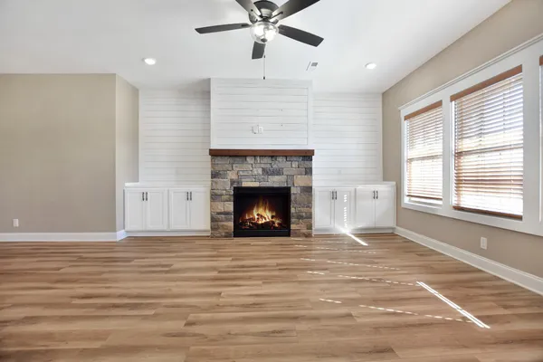 a view of a livingroom with a fireplace and window