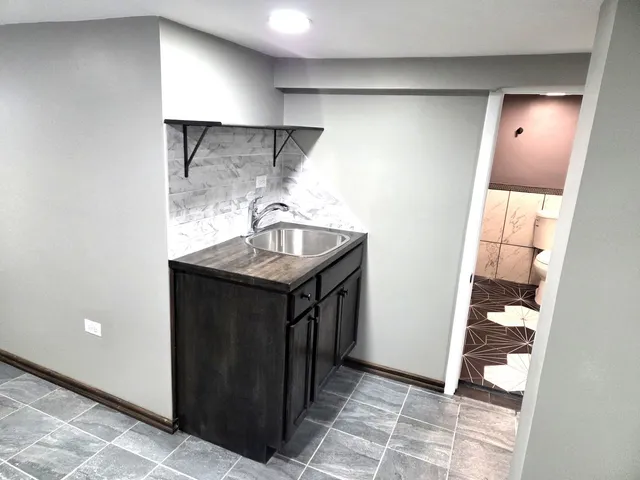 a kitchen with a sink and a refrigerator