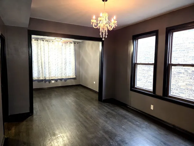 a view of a room window and wooden floor