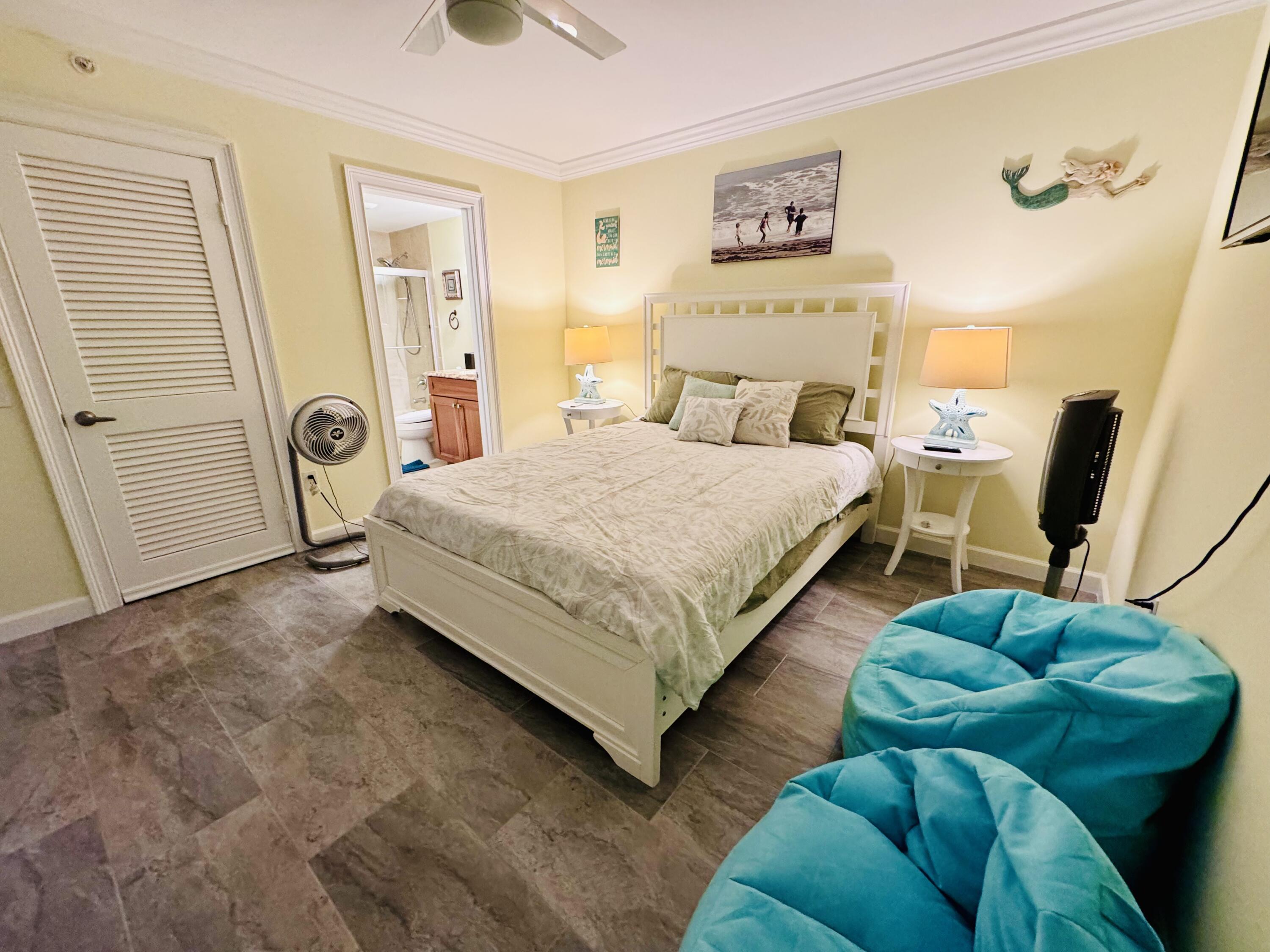 200 South Beach Road, Unit 403 Tequesta, FL 33469 - Photo 21 of 46 a bed room with a bed and a couch