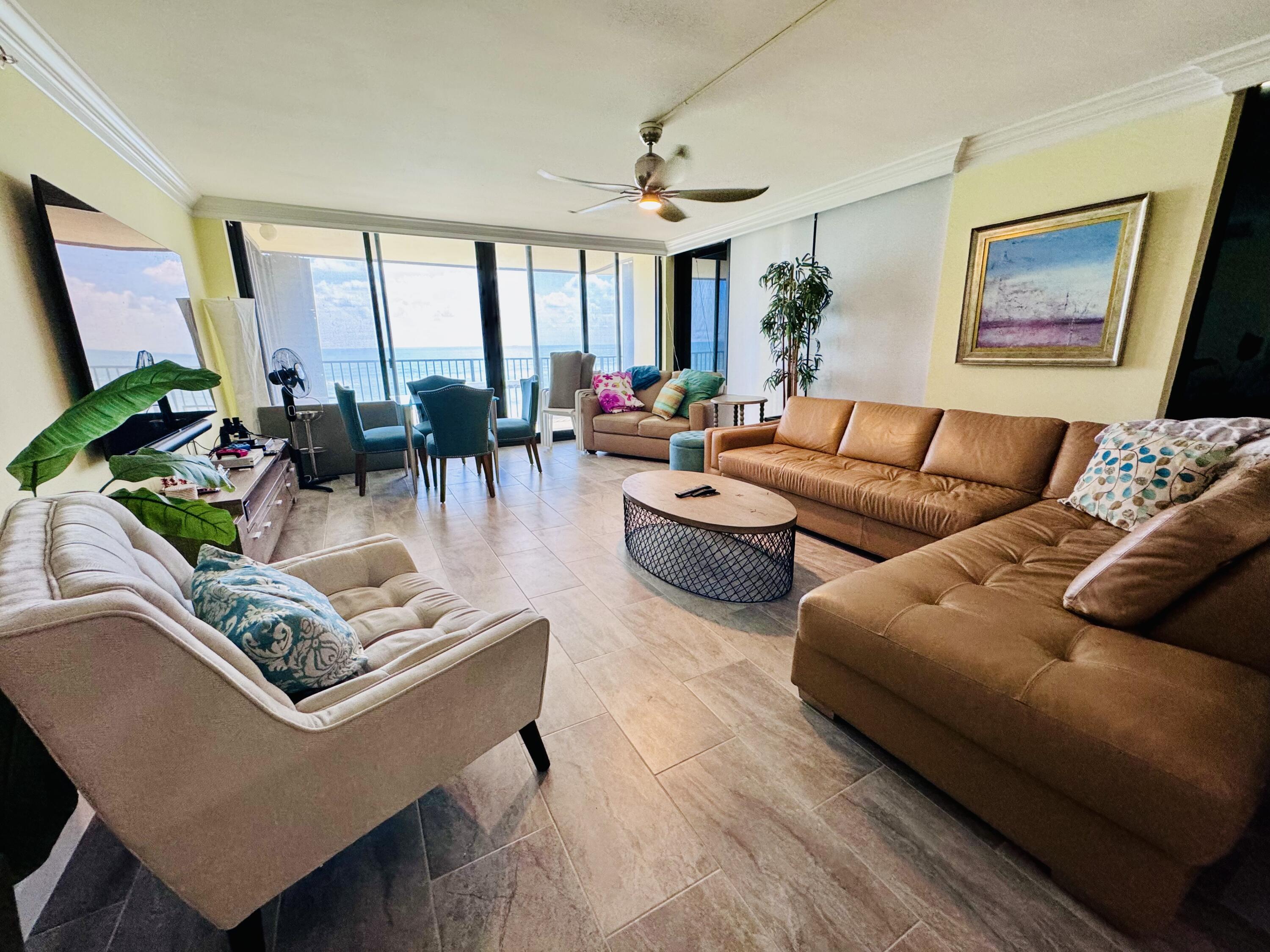 200 South Beach Road, Unit 403 Tequesta, FL 33469 - Photo 32 of 46 a living room with furniture wooden floor and a large window