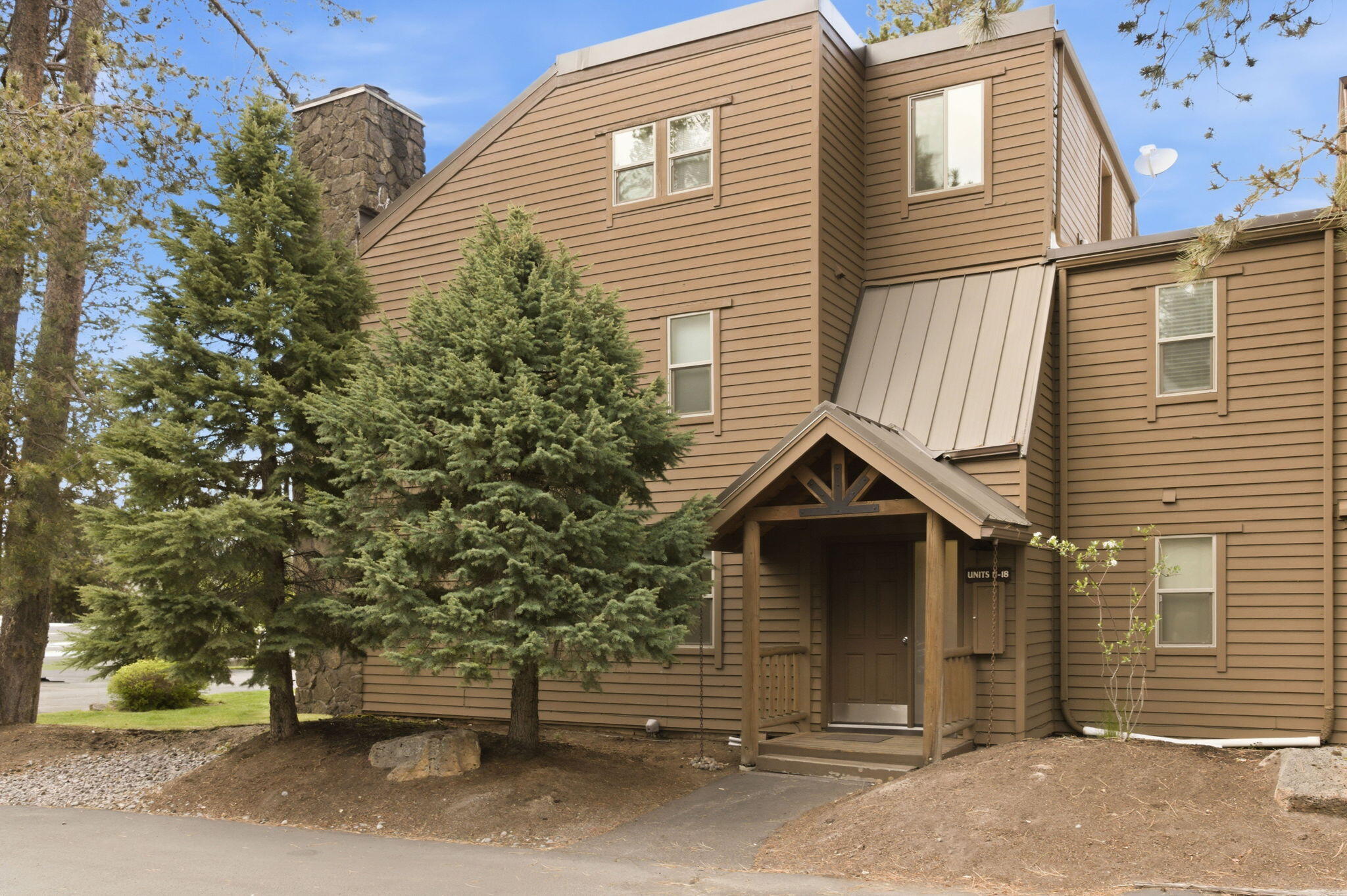 17654 Pinnacle Lane, Unit 16 Sunriver, OR 97707 - Photo 24 of 28 a view of a house with a door and wooden fence