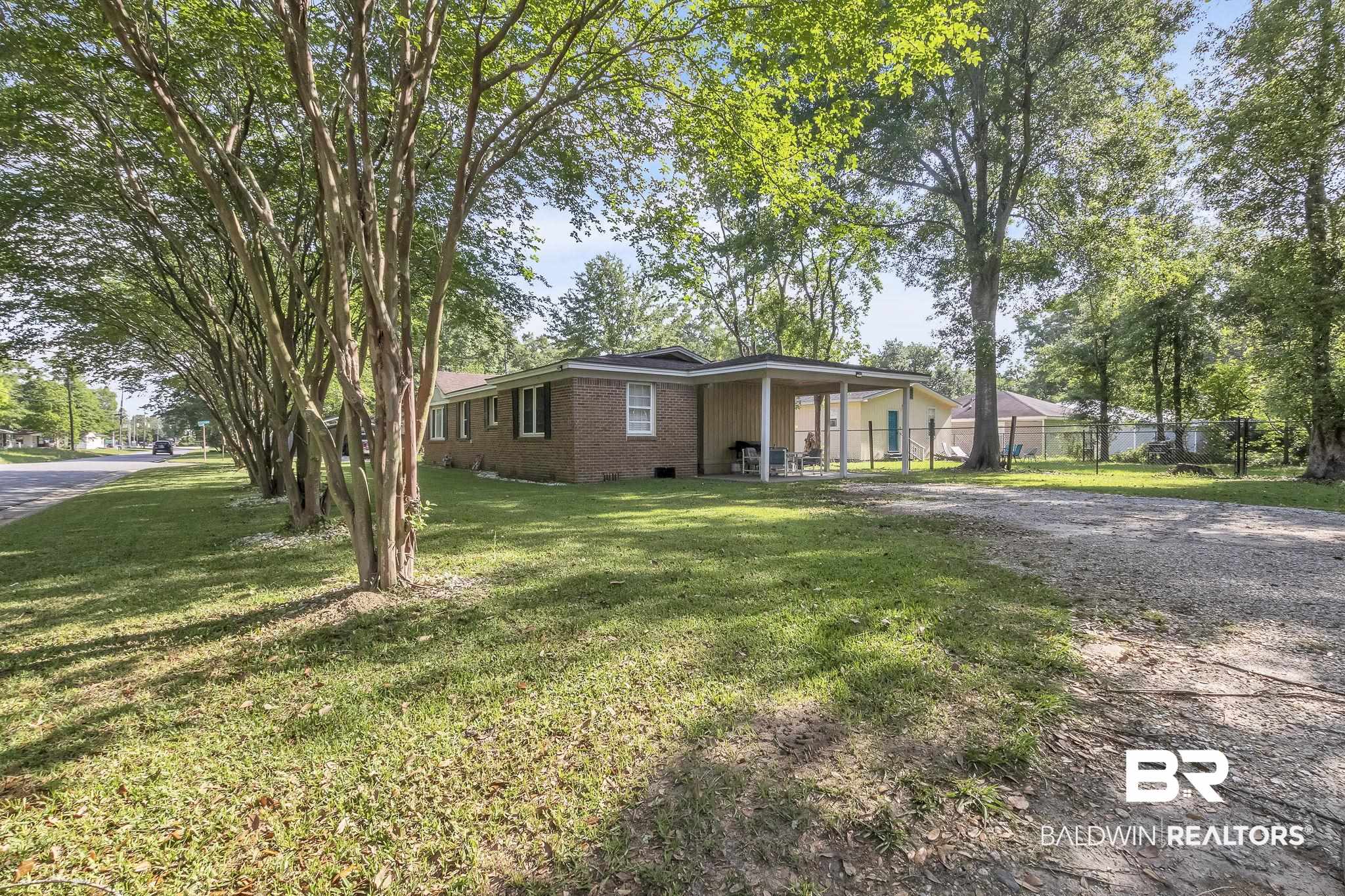 315 Fourth Avenue Chickasaw, AL 36611 - Photo 9 of 28 Ranch-style home with a front lawn, fence, brick siding, crawl space, and driveway