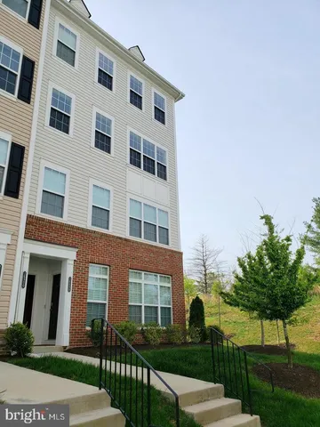 a front view of a building with a yard