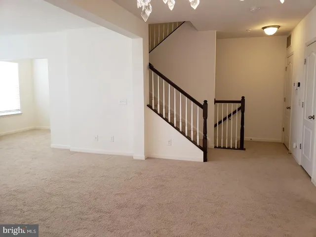 a view of an empty room with stairs