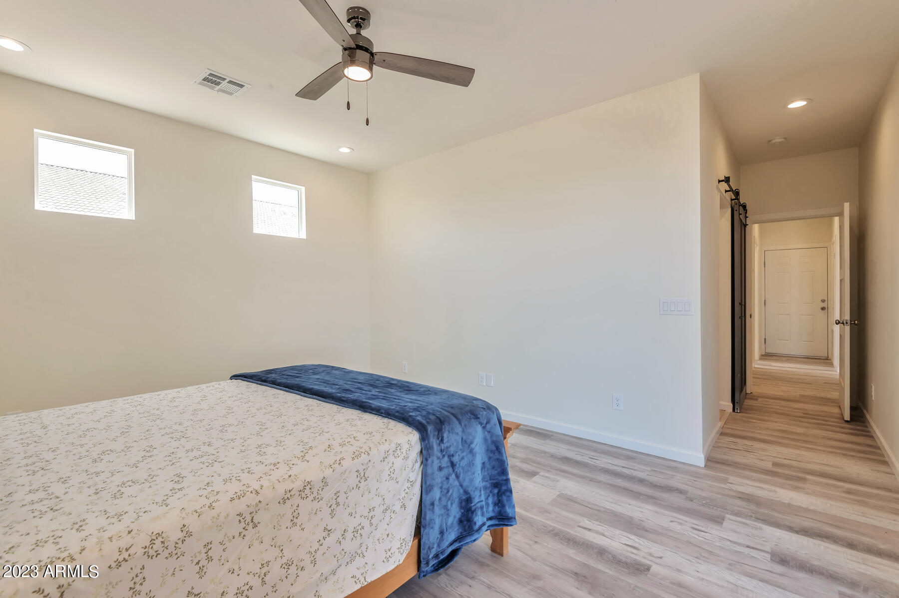 15200 South Diablo Road Arizona City, AZ 85123 - Photo 14 of 23 a bedroom with a bed and wooden floor