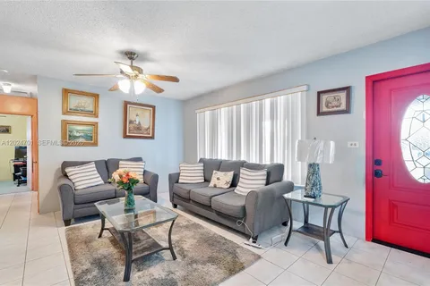 a living room with furniture a couch and a window