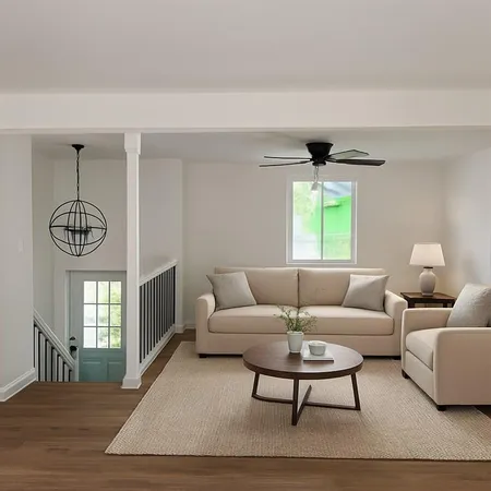 a living room with furniture a chandelier and a window