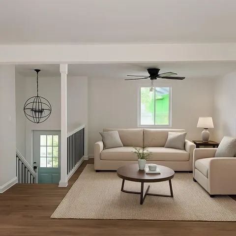 a living room with furniture a chandelier and a window