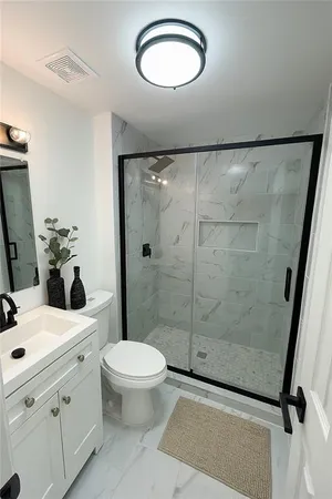 a bathroom with a sink toilet and shower