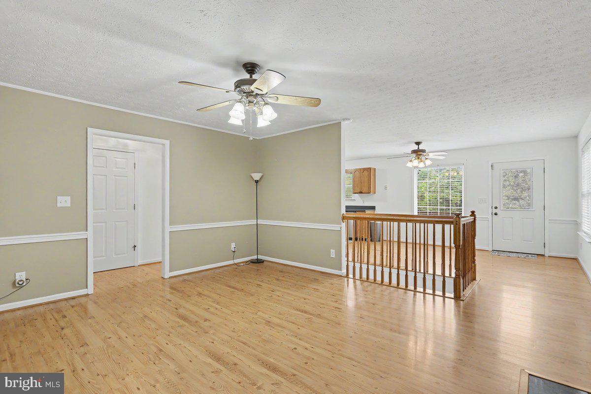543 Whiskey Still Road Linden, VA 22642 - Photo 9 of 23 wooden floor in an empty room with a window