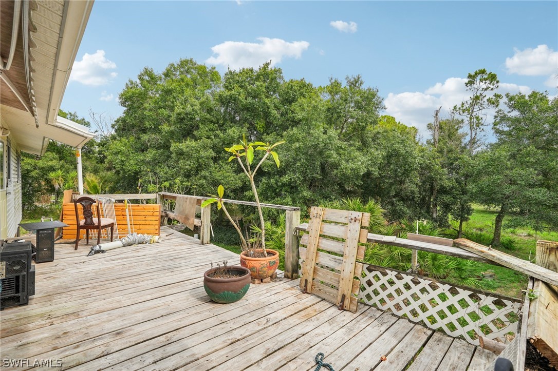 23701 North River Road Alva, FL 33920 - Photo 7 of 18 a balcony with furniture and wooden floor