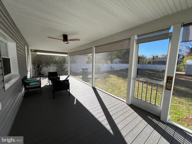 a view of a room with balcony and wooden floor