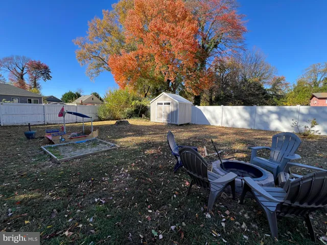 a view of a chairs and table in the backyard
