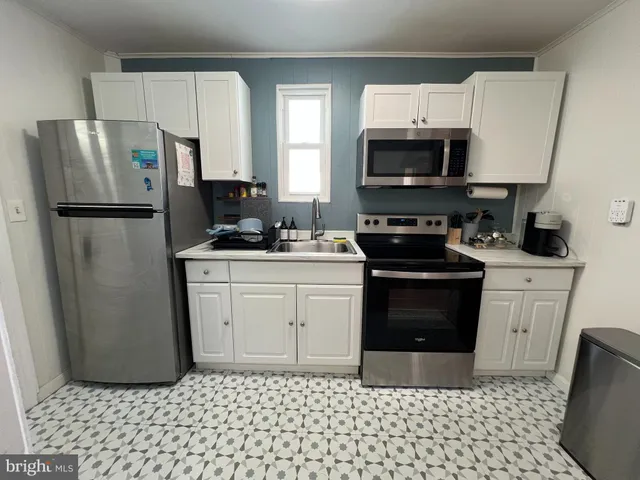 a kitchen with a sink stove and refrigerator