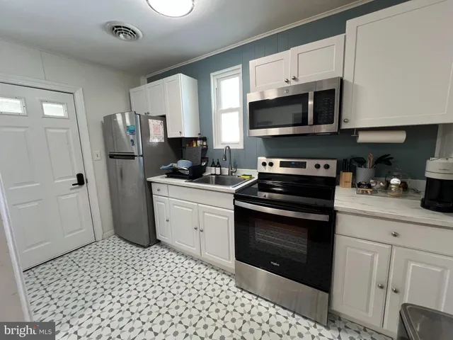 a kitchen with a sink stove and refrigerator