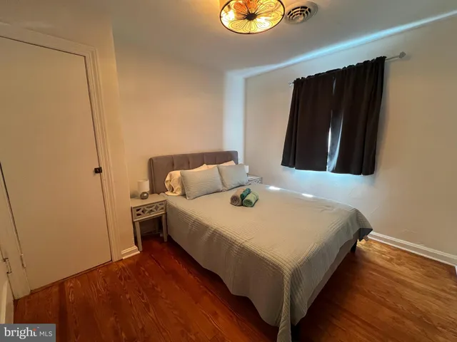 a bedroom with a bed and a mirror