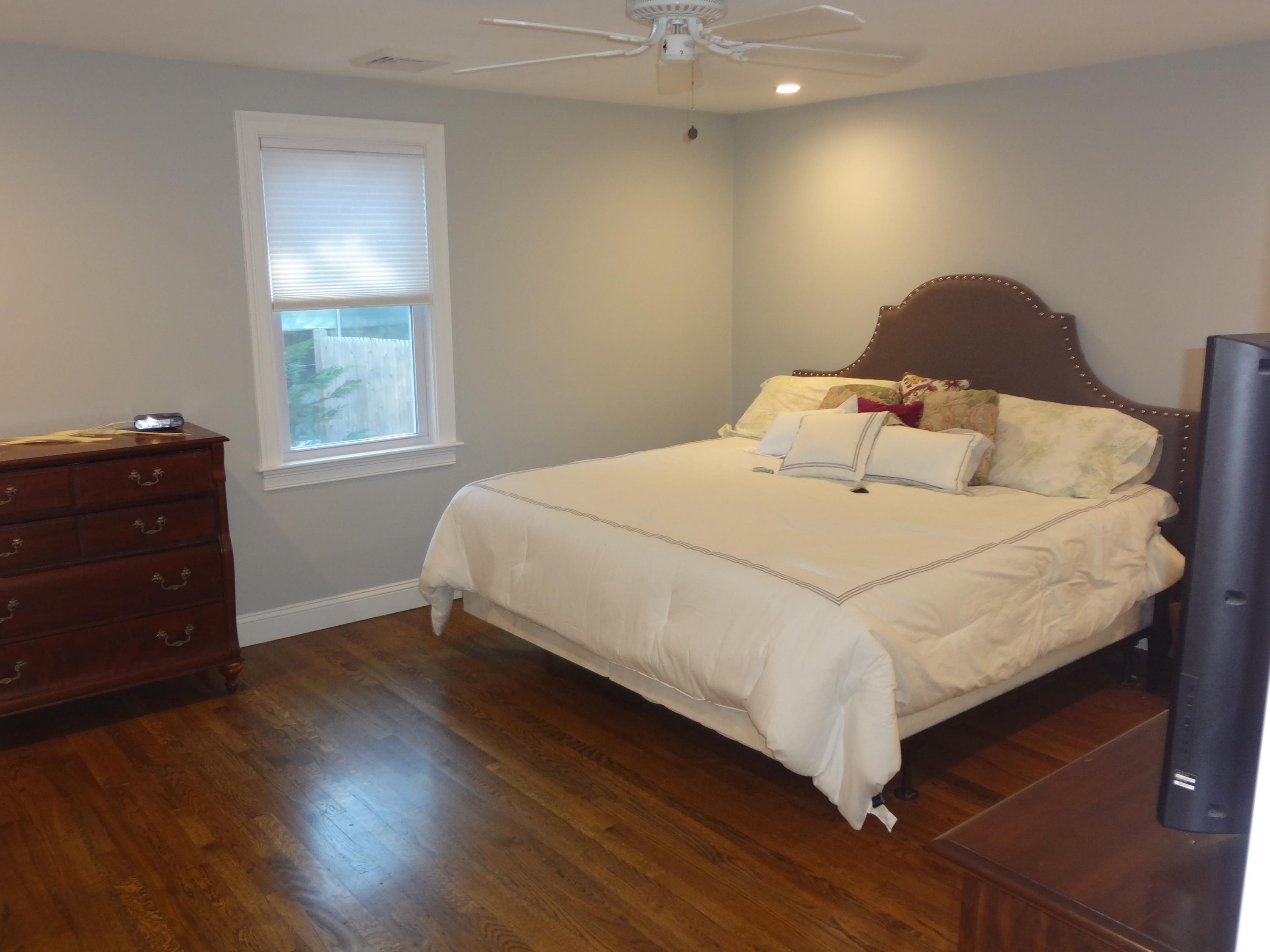 91 Ansel Howland Road Centerville, MA 02632 - Photo 16 of 30 a bedroom with a bed and wooden floor