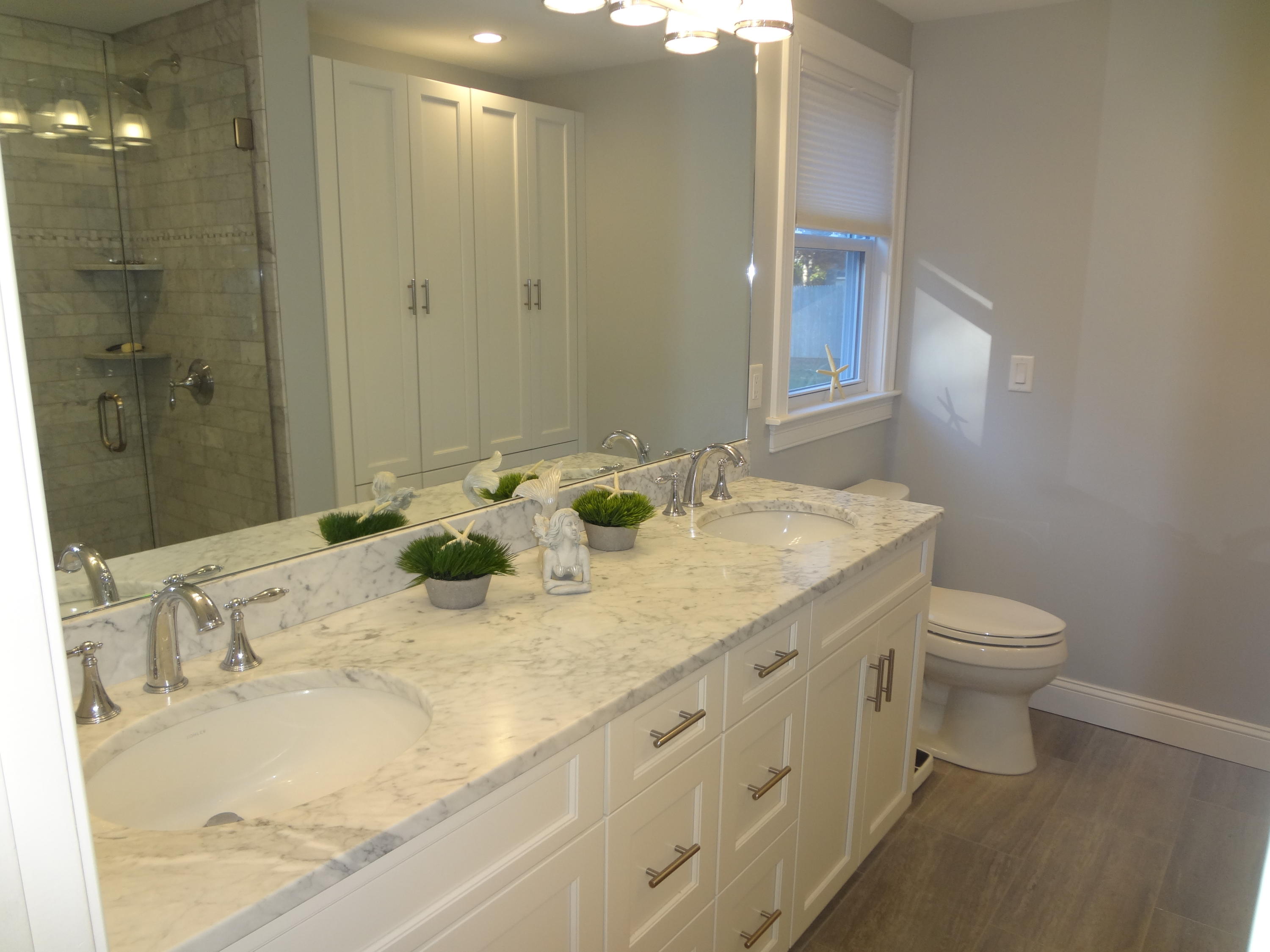 91 Ansel Howland Road Centerville, MA 02632 - Photo 18 of 30 a bathroom with a granite countertop sink a toilet and a mirror