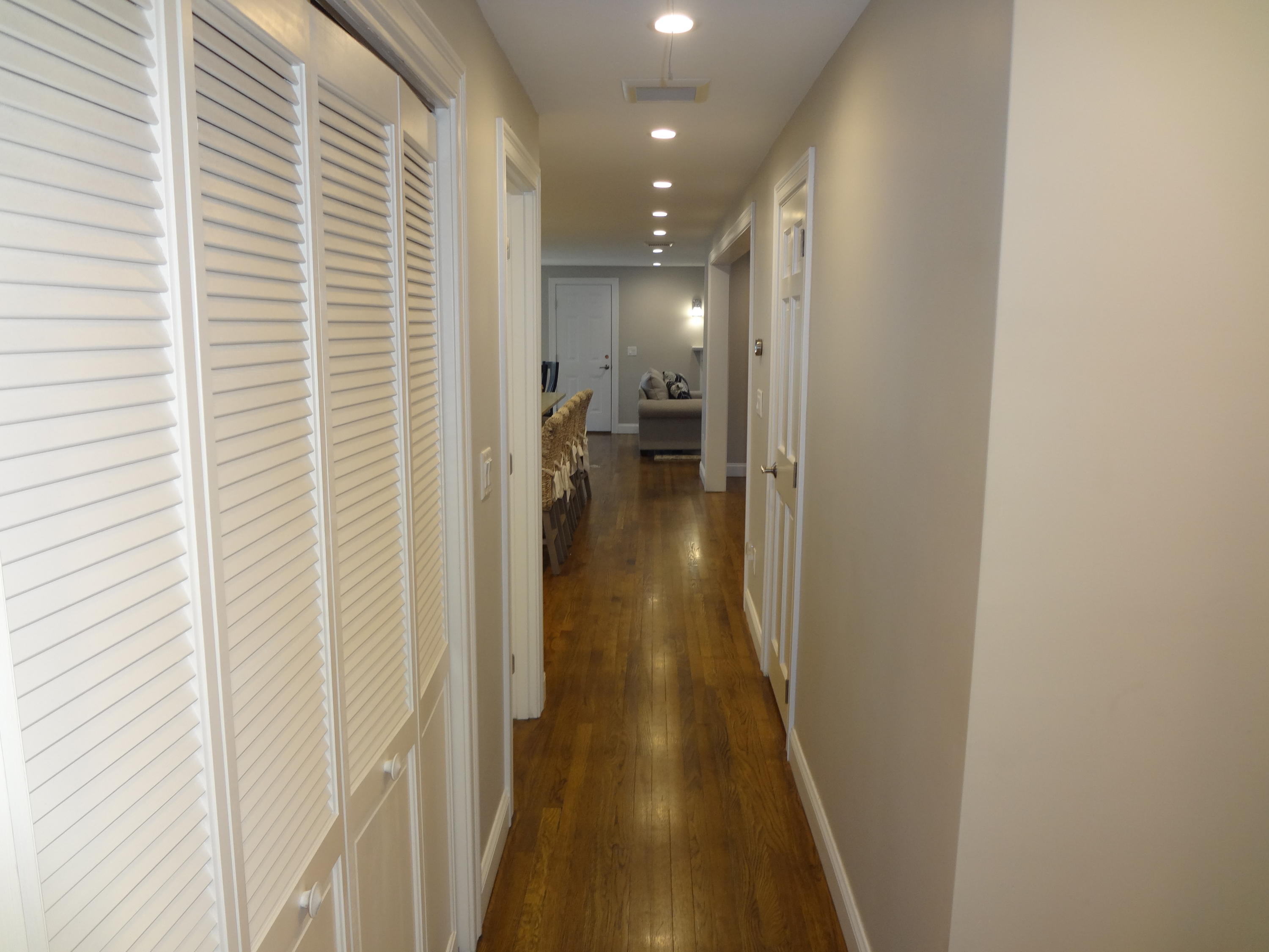 91 Ansel Howland Road Centerville, MA 02632 - Photo 23 of 30 a view of a hallway with wooden floor and a bathroom