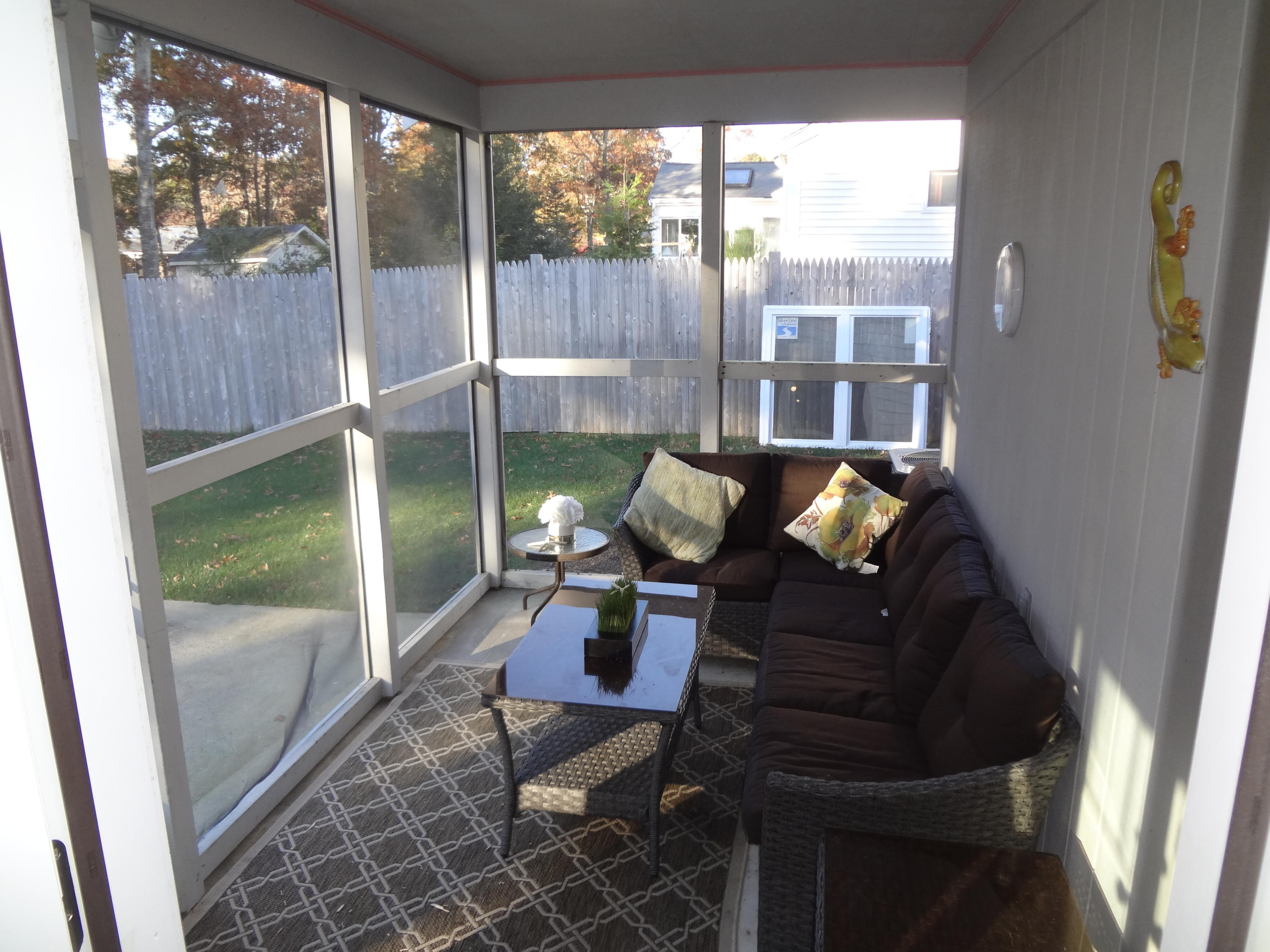 91 Ansel Howland Road Centerville, MA 02632 - Photo 25 of 30 a living room with couches and a floor to ceiling window