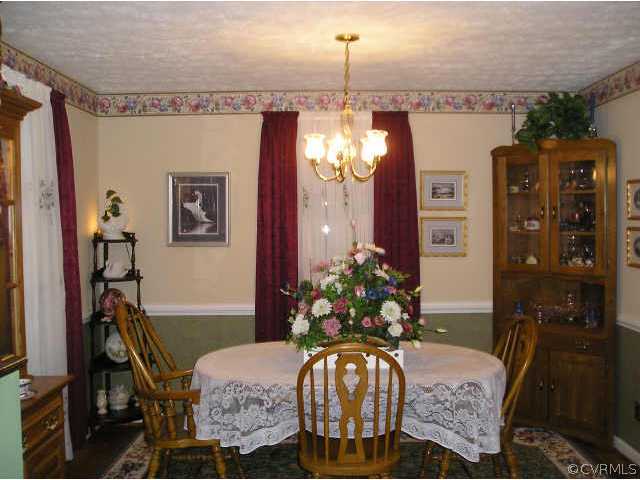 5325 Chesdin Road Petersburg, VA 23803 - Photo 3 of 8 a dining room with furniture a chandelier and window
