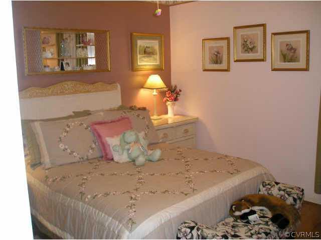 5325 Chesdin Road Petersburg, VA 23803 - Photo 7 of 8 a bedroom with a bed and painting on the wall