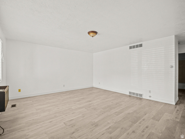 460 200 South Provo, UT 84606 - Photo 14 of 66 Unfurnished living room featuring light wood-style floors and a textured ceiling