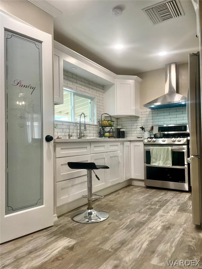1395 Lause Road Bullhead City, AZ 86442 - Photo 11 of 34 Kitchen featuring white shaker-style cabinetry and pantry