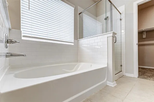 a white bath tub sitting next to a white sink