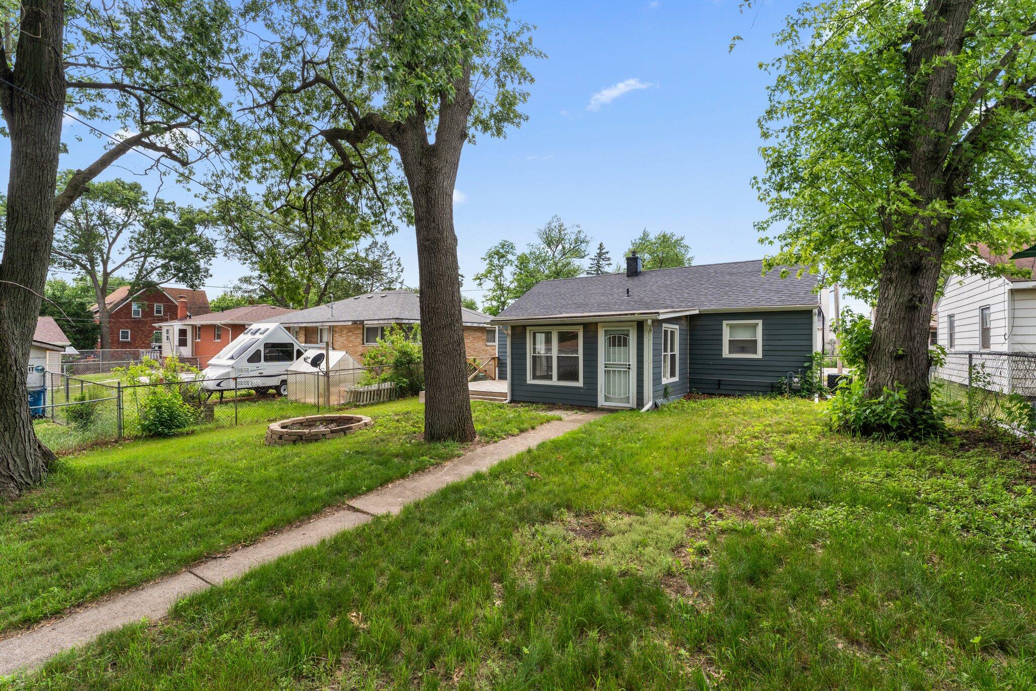 355 South Howard Street Gary, IN 46403 - Photo 15 of 16 a front view of a house with yard and green space