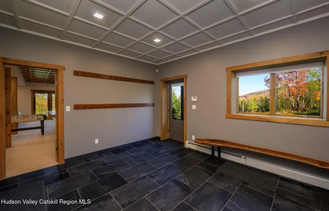 a view of a balcony with chairs and wooden floor