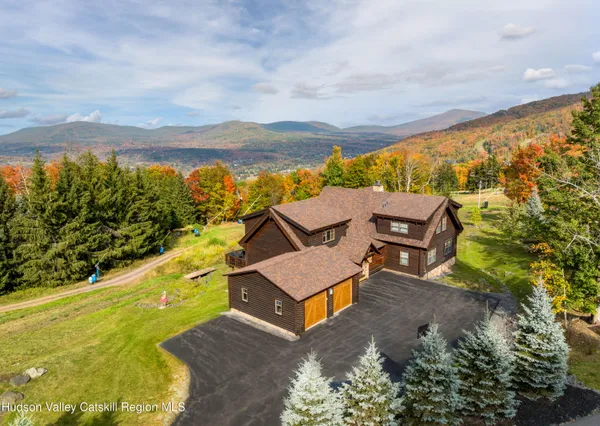 an aerial view of a house with a yard pool outdoor seating and yard