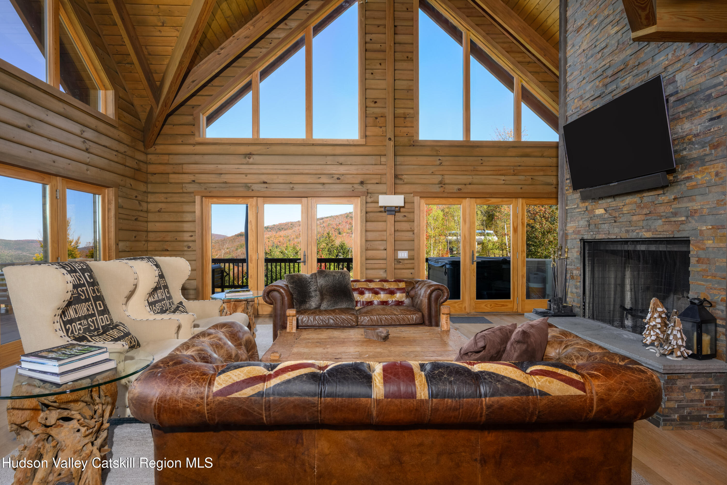 209 Club Road Windham, NY 12496 - Photo 4 of 18 a view of a patio with couches table and chairs with potted plants