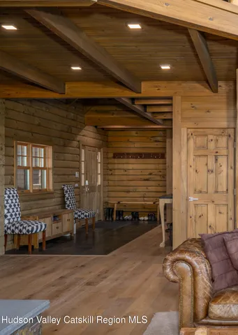 a bed sitting in a spacious bedroom next to a window